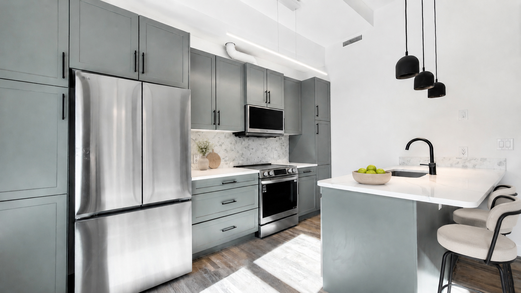 Modern kitchen with stainless steel appliances in 1 bedroom apartment at The Whitney Block, downtown Lethbridge